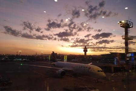 View from the airport building of an airplane being prepared for take-off. 