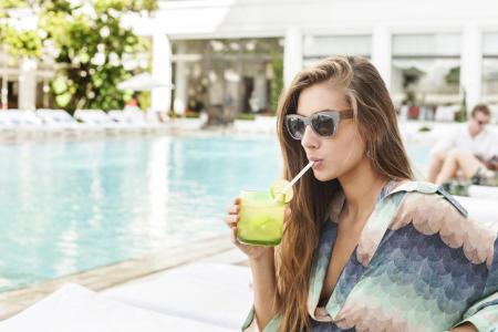 Woman Enjoying a Refreshing Cocktail by the Pool