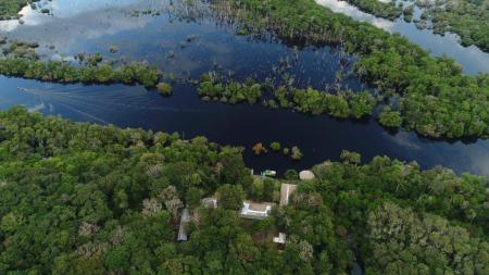 Aerial view of the Tupana Lodge surrounded by the Amazon rainforest and waterways.